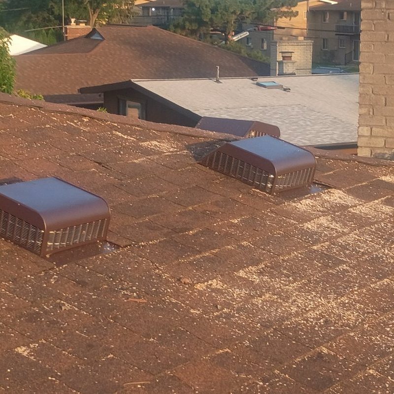Roof vents on a brown shingle roof